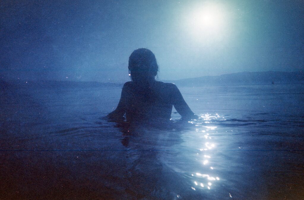 woman drenched under blued moonlight